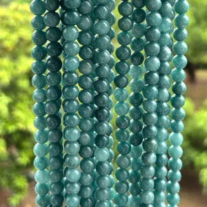 Detailed macro view of high-quality emerald green chalcedony round beads for jewelry