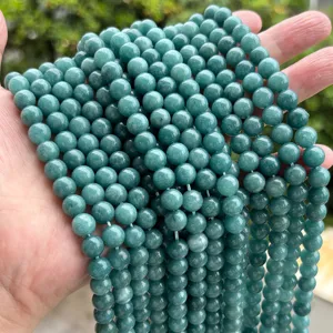 Close-up of premium teal chalcedony beads displaying vibrant color and smooth texture