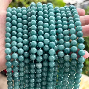 Macro view of jade-green chalcedony round beads showing natural texture and smooth finish.