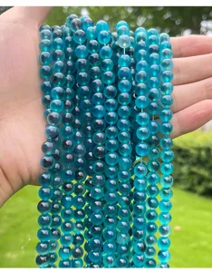 Close-up detail of translucent blue sugar heart agate round beads for DIY jewelry making.