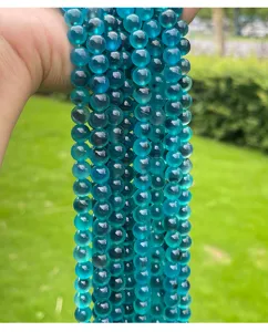 Close-up detail of translucent bright blue sugar heart agate 6mm round loose beads for DIY crafts