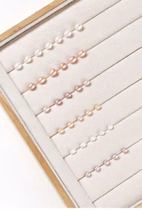 Detailed view of natural rice-shaped freshwater pearls in pastel shades for DIY jewelry.