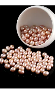 Macro detail of natural lavender pink rice-shaped freshwater pearls with high luster.