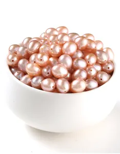Close-up of natural pink rice-shaped freshwater pearls with high luster in a white bowl