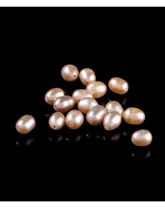 Close-up of natural pink rice-shaped freshwater pearls showing fine luster and texture.