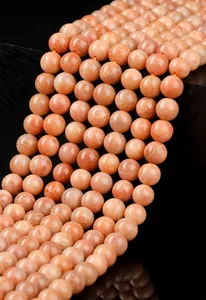 Close-up detail of polished natural red amazonite round beads for handmade jewelry crafts