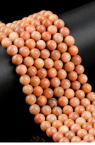 Detailed macro view of natural polished red Amazonite gemstone beads for DIY jewelry