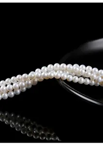 Close-up detail of white natural freshwater pearl round beads for jewelry making