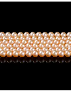 Macro detail of high-luster pink natural freshwater pearl round beads for DIY jewelry