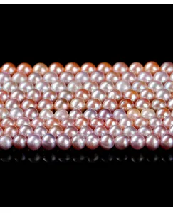 Detailed view of natural freshwater round pearls showing pink and purple luster.