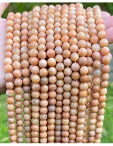Detailed view of natural round peach red amazonite loose beads for DIY jewelry making