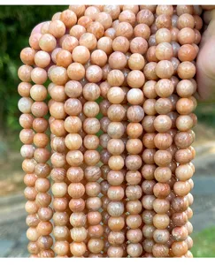 Close-up of natural peach-colored amazonite round stone beads for DIY jewelry