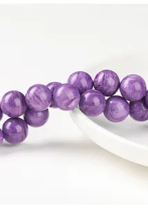 Close-up of purple imitation Charoite round beads for DIY jewelry making accessories.