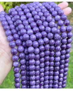 Macro close-up detail of synthetic purple charoite-style beads for DIY jewelry making