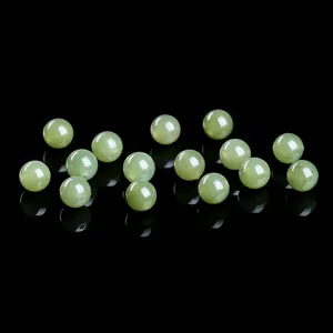 Macro view of natural Qingshui green Hetian jade round beads for DIY jewelry making
