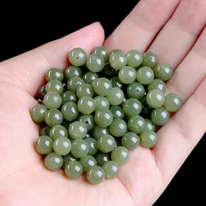 Detailed macro view of natural light green Hetian jade round beads for DIY jewelry making