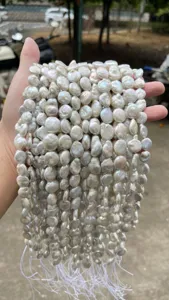 Detailed close-up showing iridescent luster of natural baroque coin pearls strands
