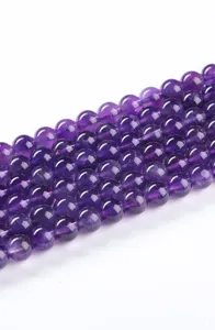 Macro close-up detail of natural deep purple amethyst round beads for DIY jewelry making