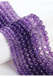 Macro view showing the polished texture and clarity of natural purple amethyst round beads