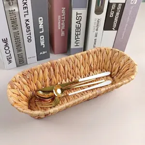 Detailed view of hand-woven grass storage basket with elegant gold cutlery inside