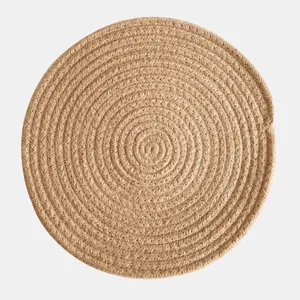 Close-up macro detail of a circular braided jute placemat showing natural fiber texture
