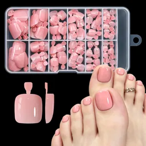 Detailed view of glossy nude pink press-on toe nails with foot model demonstration