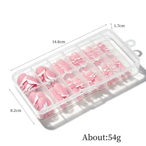 Detailed macro view of 120pcs French tip press-on toenails in a clear storage box