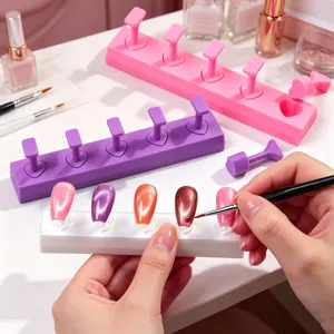 Detailed view of DIY nail art practice stands being used for cat-eye nail painting.