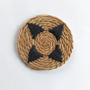 Close-up macro view of a thickened round cattail grass woven placemat with black accents