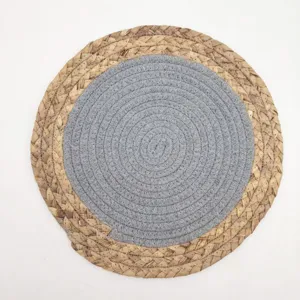 Detailed macro view showing woven straw and grey cotton rope texture on a round placemat