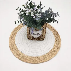 Detail view of bicolor round woven placemat with cotton rope and natural grass