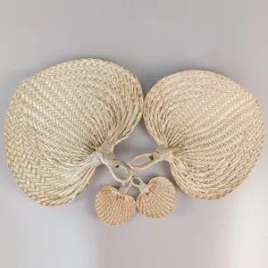 Detailed view of hand-woven palm leaf fans showing natural texture and weaving patterns