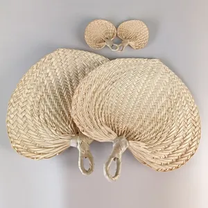 Handmade natural palm leaf fans in various sizes for summer cooling and rustic home decor