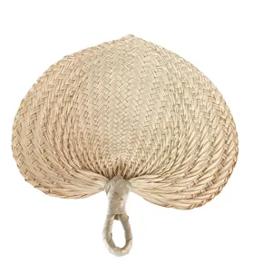 Hand-woven natural palm leaf cooling fan with traditional straw texture and handle loop.