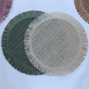 Close-up detail of round woven paper rope placemat featuring elegant fringe edge design.