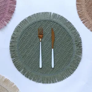 Round paper rope woven placemat with fringe detail, elegant sage green table mat for home decor.
