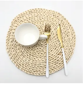 Handcrafted corn husk woven placemat with elegant ceramic cup and tableware set for daily dining.