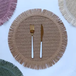 Detailed shot of round paper rope woven placemat with fringe and hollow texture for decor.