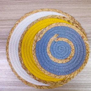 Detailed shot of handmade woven straw and cotton rope placemats, heat resistant circle table mat.