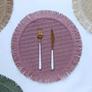 Round paper rope woven placemat with delicate fringe edge, perfect for kitchen table decor setup.