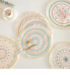 Detailed view of multiple Bohemian round cotton placemats with colorful prints and fringes.