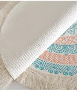 Close-up detail of a woven Bohemian round placemat with tassel fringe and printed pattern