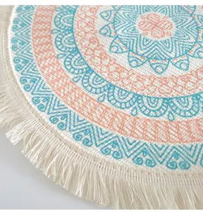 Close-up of bohemian woven cotton placemat with colorful print and fringe detail