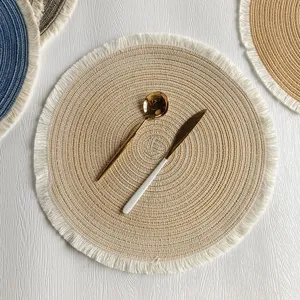 Round woven cotton placemat with fringe, stylish table decor mat and heat resistant dining pad.