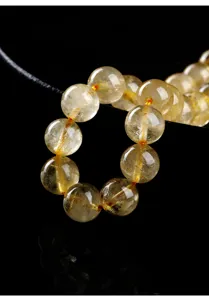 Macro detail of natural golden rutilated quartz beads showing internal textures