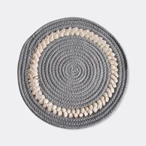 Detailed shot of Nordic cotton braided round heat insulation placemat, grey and beige design.