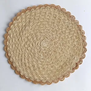 Exquisite woven paper straw placemat detail, featuring intricate concentric patterns.
