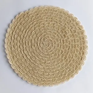 Close-up detail of a round beige woven placemat featuring delicate wavy lace edges.