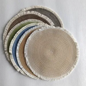 Round woven cotton placemat with fringe detail, minimalist dining table decoration mat.