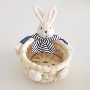 Woven storage basket featuring cute plush bunny head and blue striped scarf, perfect for home decor.